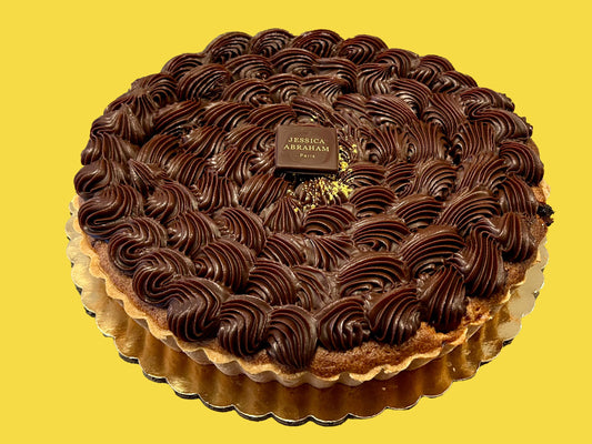 Chocolate banana tart with Jessica Abraham brand name on a yellow background