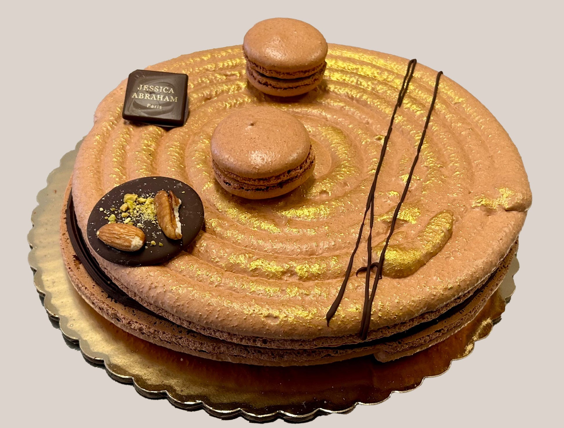 Decorative cake with macarons and chocolate elements and 'jessica abraham branding