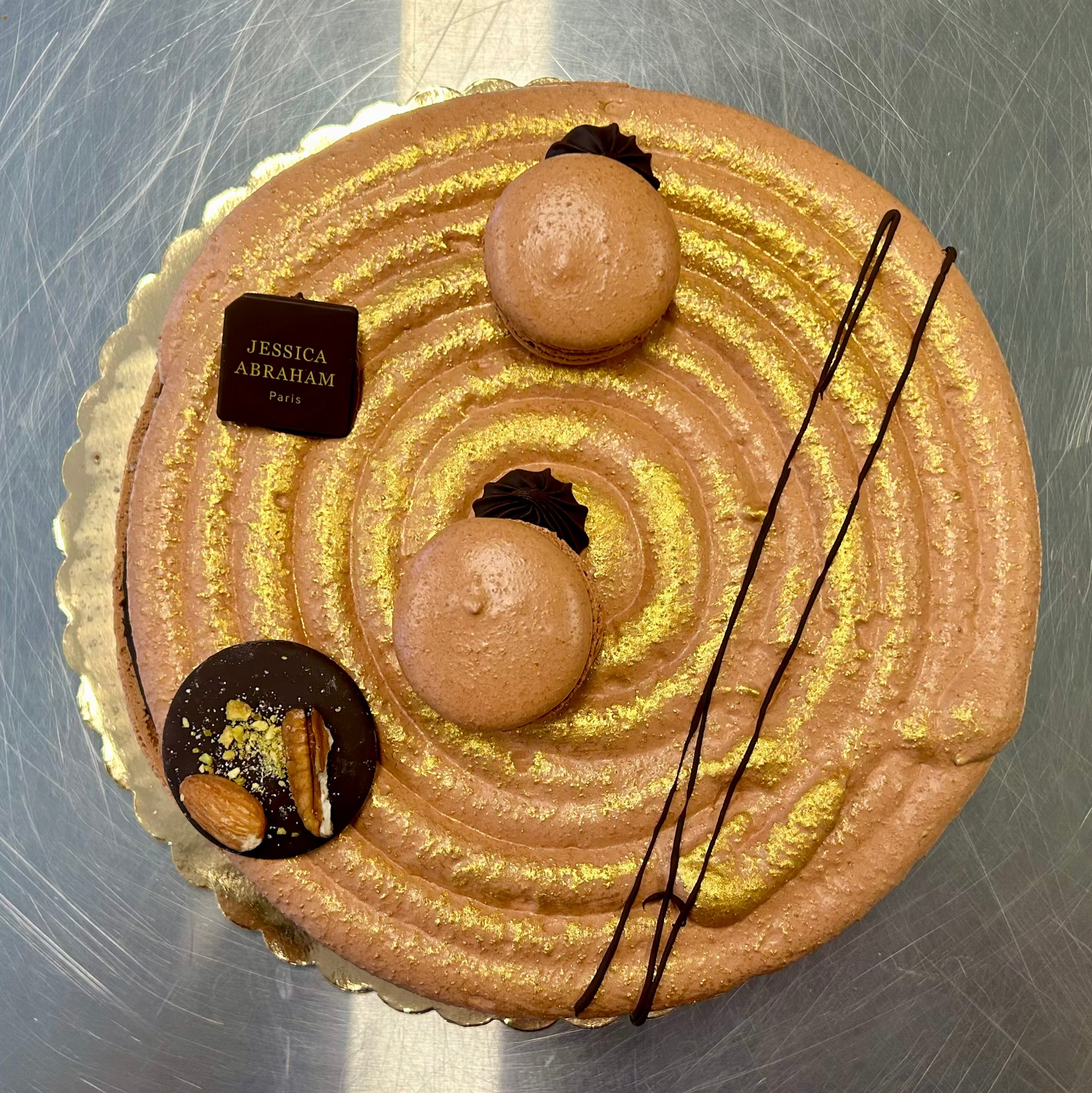 giant chocolate macaron cake with gold and brown elements and 'jessica abraham' branding