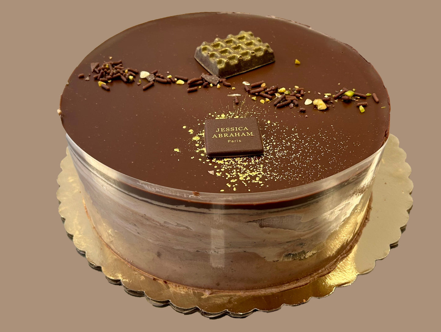 Chocolate cake with 'jessica abraham' branding on a plain background