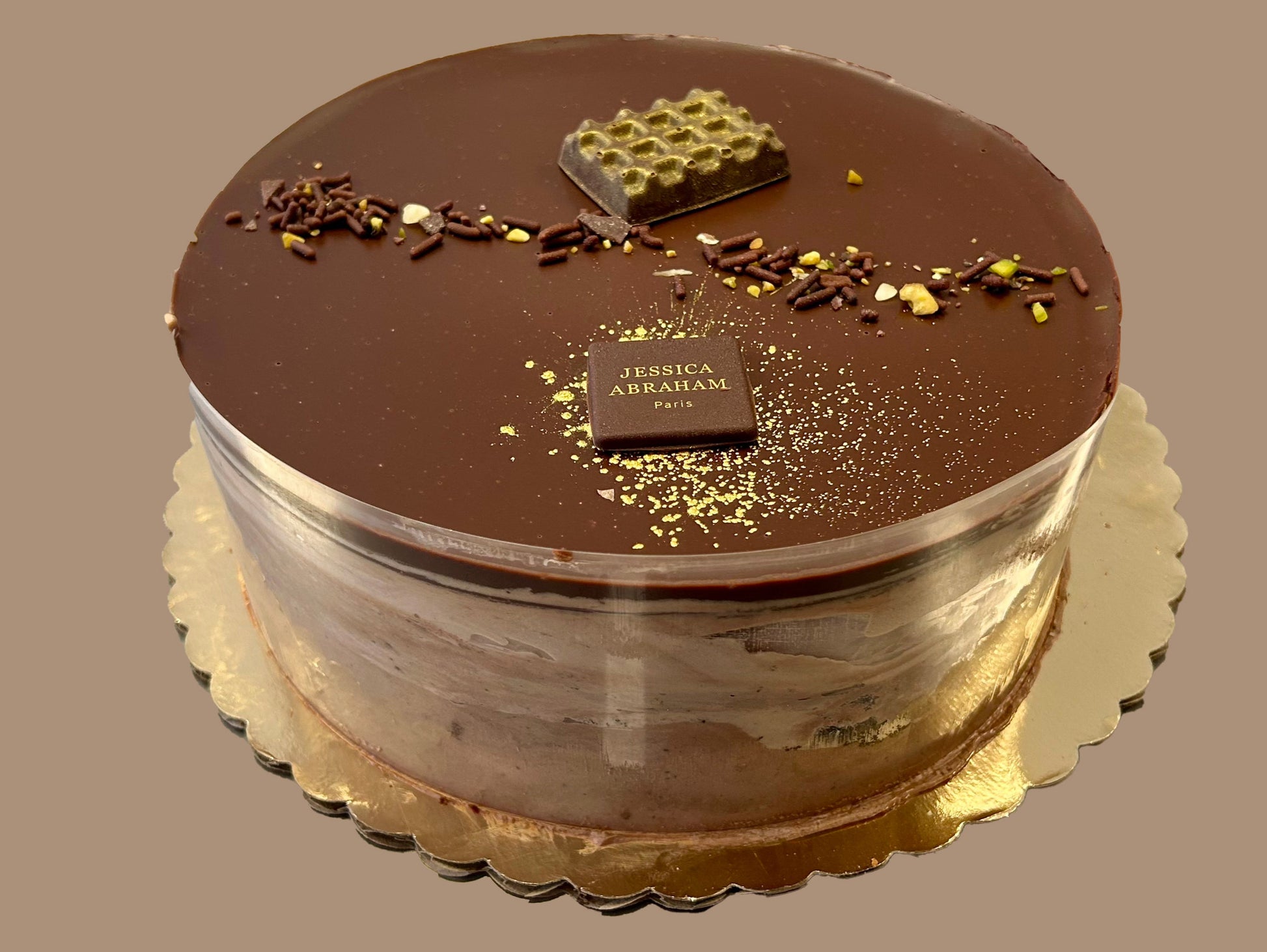Chocolate cake with 'jessica abraham' branding on a plain background